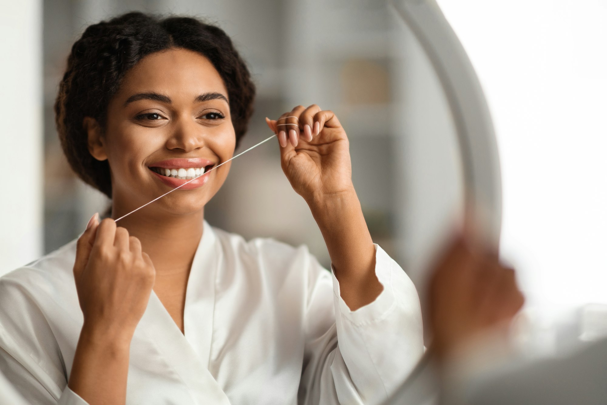 Oral Hygiene. Portrait Of Young Black Woman Using Dental Floss At Home